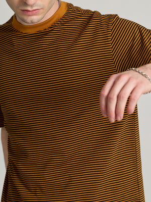 Man wearing a mustard yellow and black striped crew t-shirt