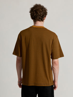 Man wearing a mustard yellow and black striped crew t-shirt