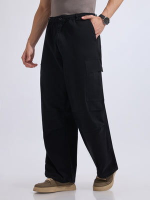 men's parachute cargo pants in black color.
