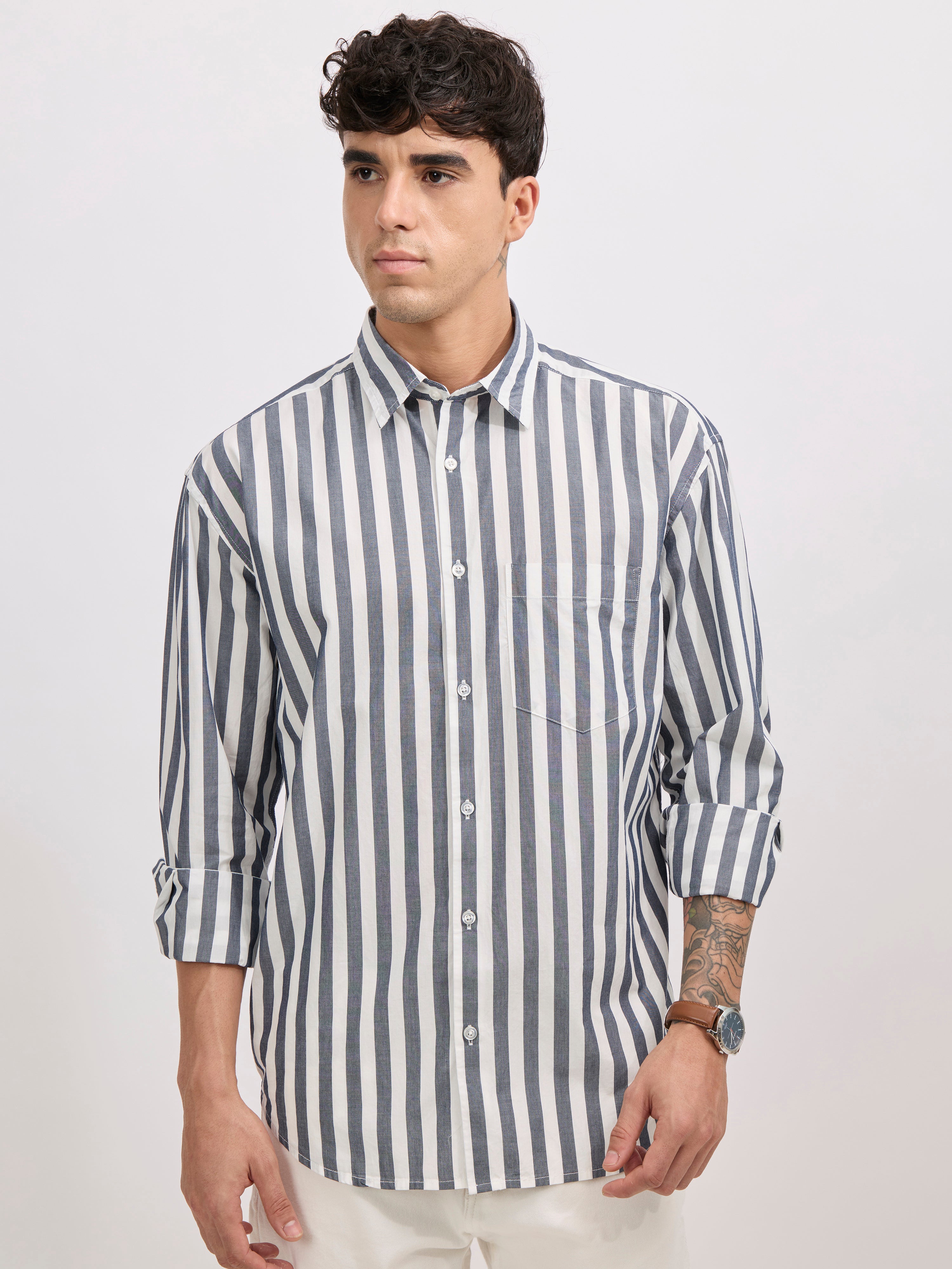 Man wearing a monochrome cotton oversized striped shirt with rolled sleeves, front pocket, and button-down collar
100% cotton
