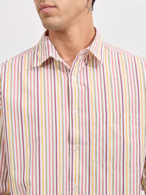 Man wearing a peach cotton oversized striped shirt with rolled sleeves, front pocket, and button-down collar
100% cotton