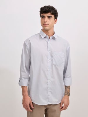 Man wearing grey cotton oversized striped shirt with rolled sleeves, front pocket, and button-down collar
100% cotton