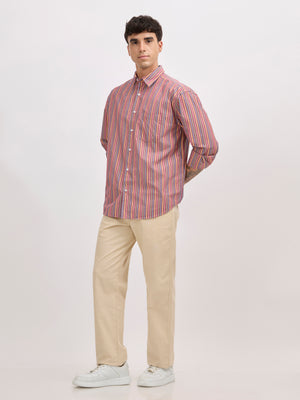 Man wearing a brick color cotton oversized striped shirt with rolled sleeves, front pocket, and button-down collar
100% cotton