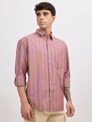 Man wearing a brick color cotton oversized striped shirt with rolled sleeves, front pocket, and button-down collar
100% cotton