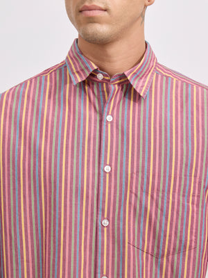 Man wearing a brick color cotton oversized striped shirt with rolled sleeves, front pocket, and button-down collar
100% cotton