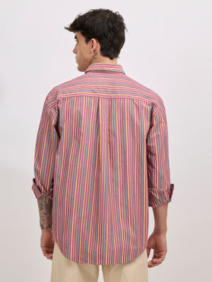 Man wearing a brick color cotton oversized striped shirt with rolled sleeves, front pocket, and button-down collar
100% cotton