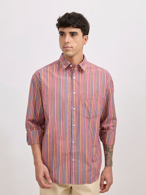 Man wearing a brick color cotton oversized striped shirt with rolled sleeves, front pocket, and button-down collar
100% cotton