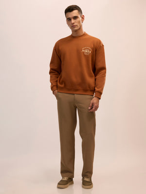 Men's brown full sleeve fleece sweater tee with front chest print and soft winterwear.