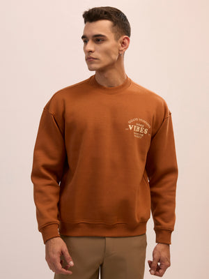 Men's brown full sleeve fleece sweater tee with front chest print and soft winterwear.
