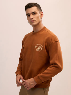 Men's brown full sleeve fleece sweater tee with front chest print and soft winterwear.