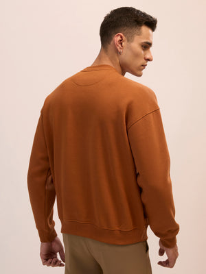 Men's brown full sleeve fleece sweater tee with front chest print and soft winterwear.