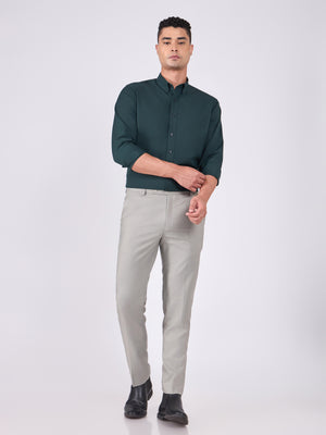 Man wearing Tencel prussian blue shirt and light gray pants on a white background