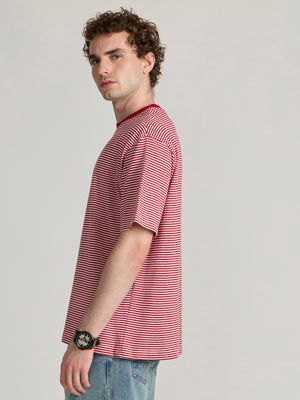Man wearing a pink and white striped crew t-shirt