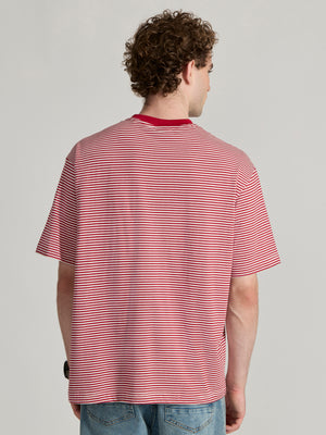 Man wearing a pink and white striped crew t-shirt