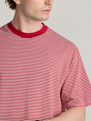 Man wearing a pink and white striped crew t-shirt