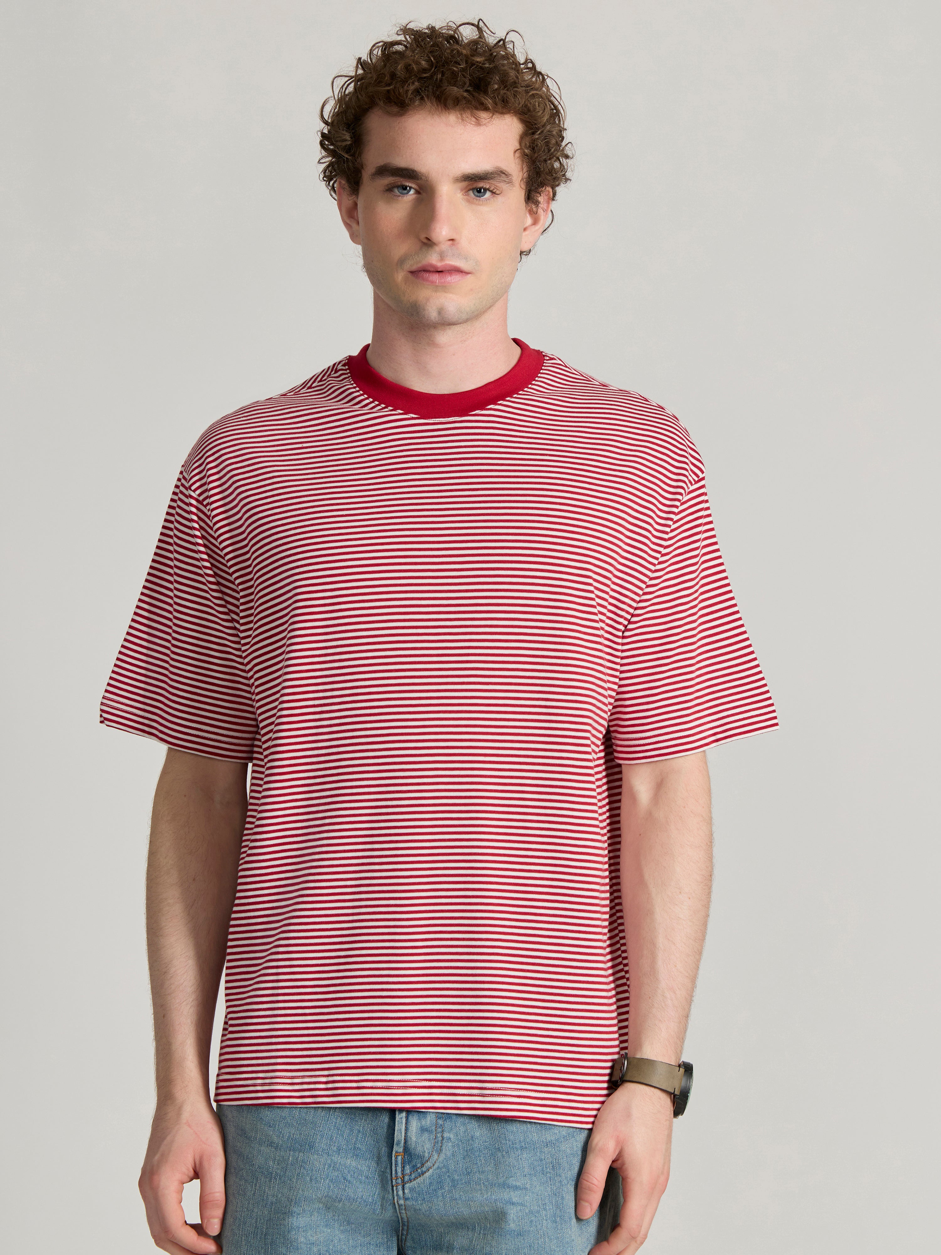 Man wearing a pink and white striped crew t-shirt
