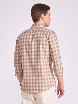 Man wearing a brown checkered shirt.