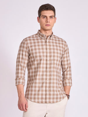 Man wearing a brown checkered shirt .