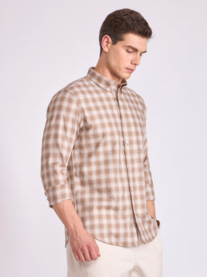 Man wearing a brown checkered shirt.