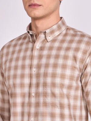 Man wearing a brown checkered shirt.