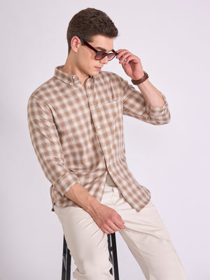 Man wearing a brown checkered shirt.