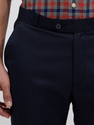 men's navy blue skinny fit trousers blended with polyster and spandex - paired with a black top and black shoes.