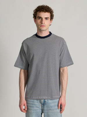 Man wearing a navy blue striped crew t-shirt