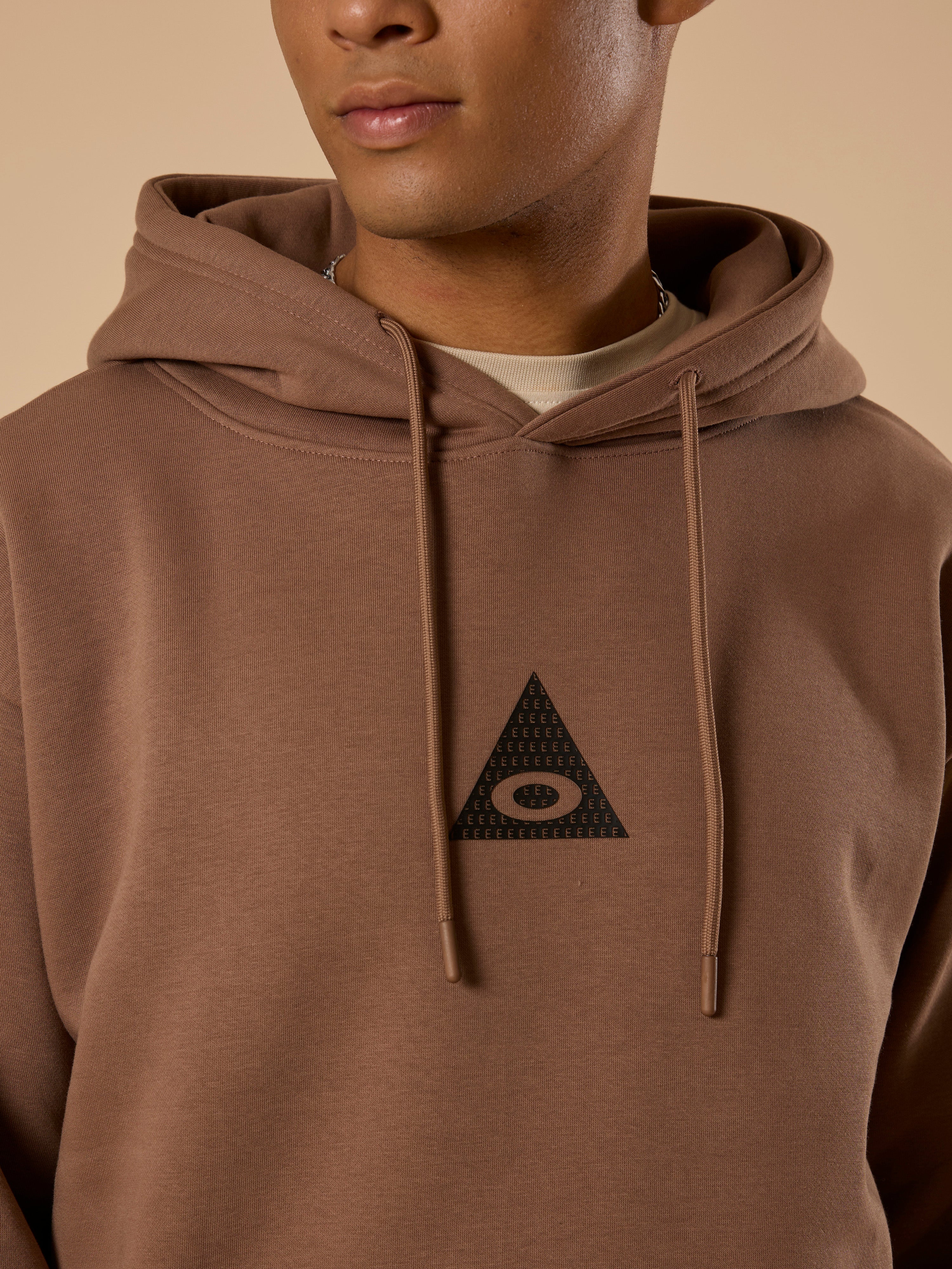 men's light brown long sleeve hoodie with minimal print, cotton and polyster blended.