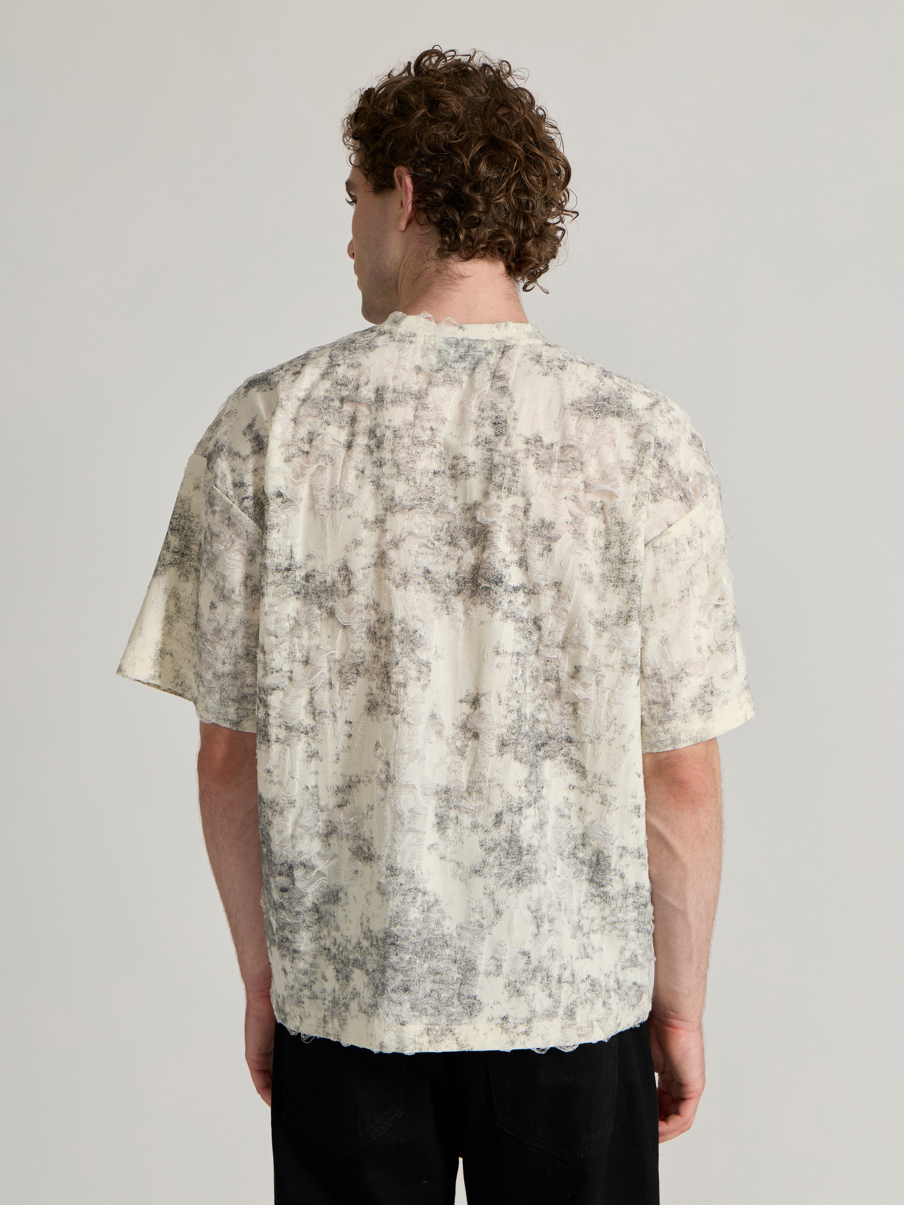 man wearing a Distressed Oversized T-Shirt - black