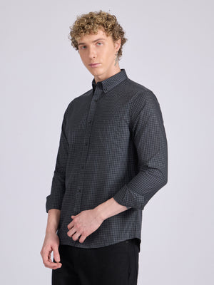 Man wearing a dark steel blue micro checkered shirt .