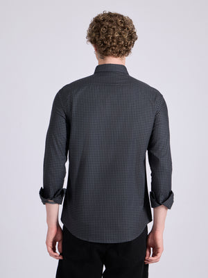 Man wearing a dark steel blue micro checkered shirt .
