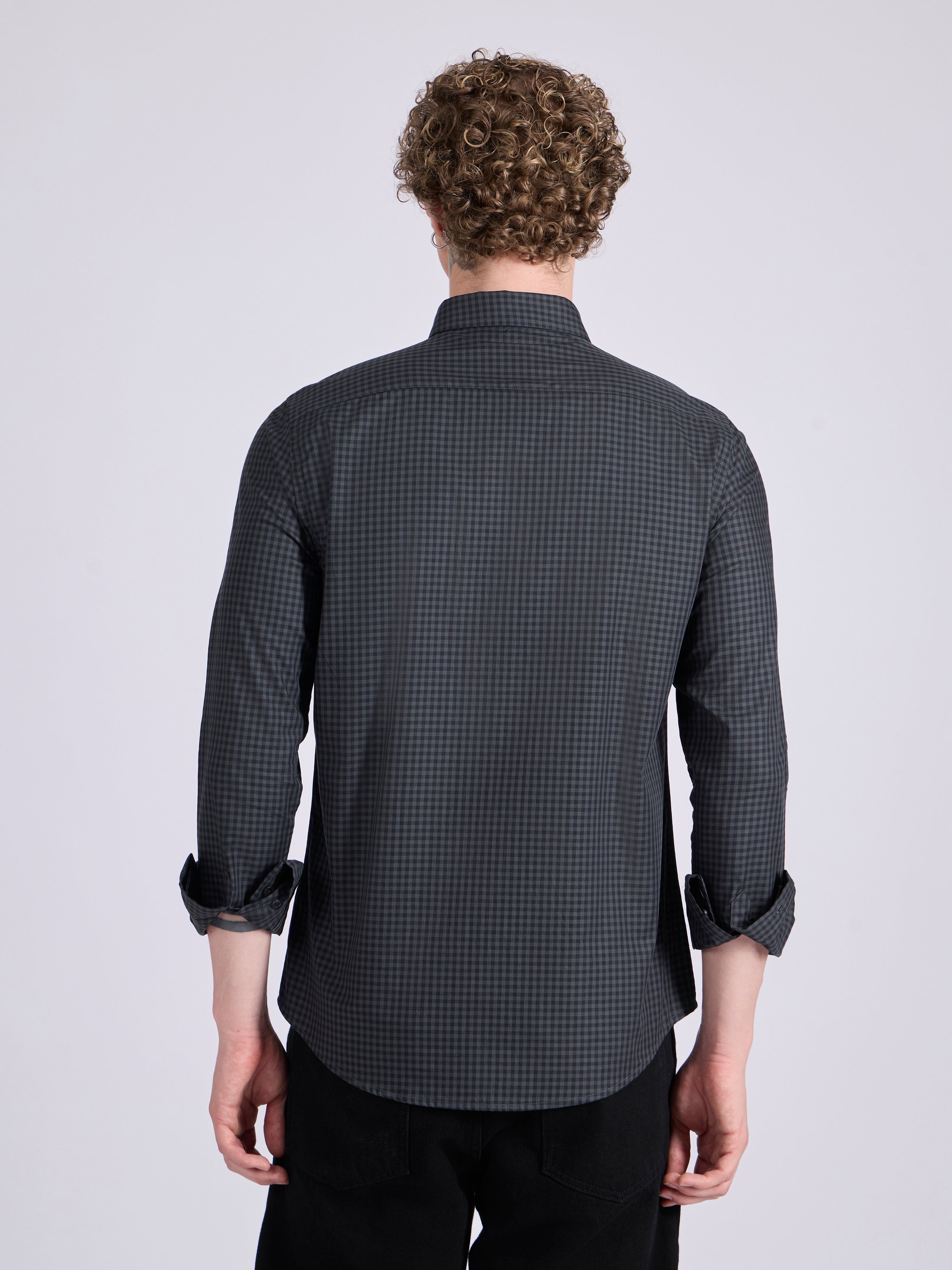 Man wearing a dark steel blue micro checkered shirt .