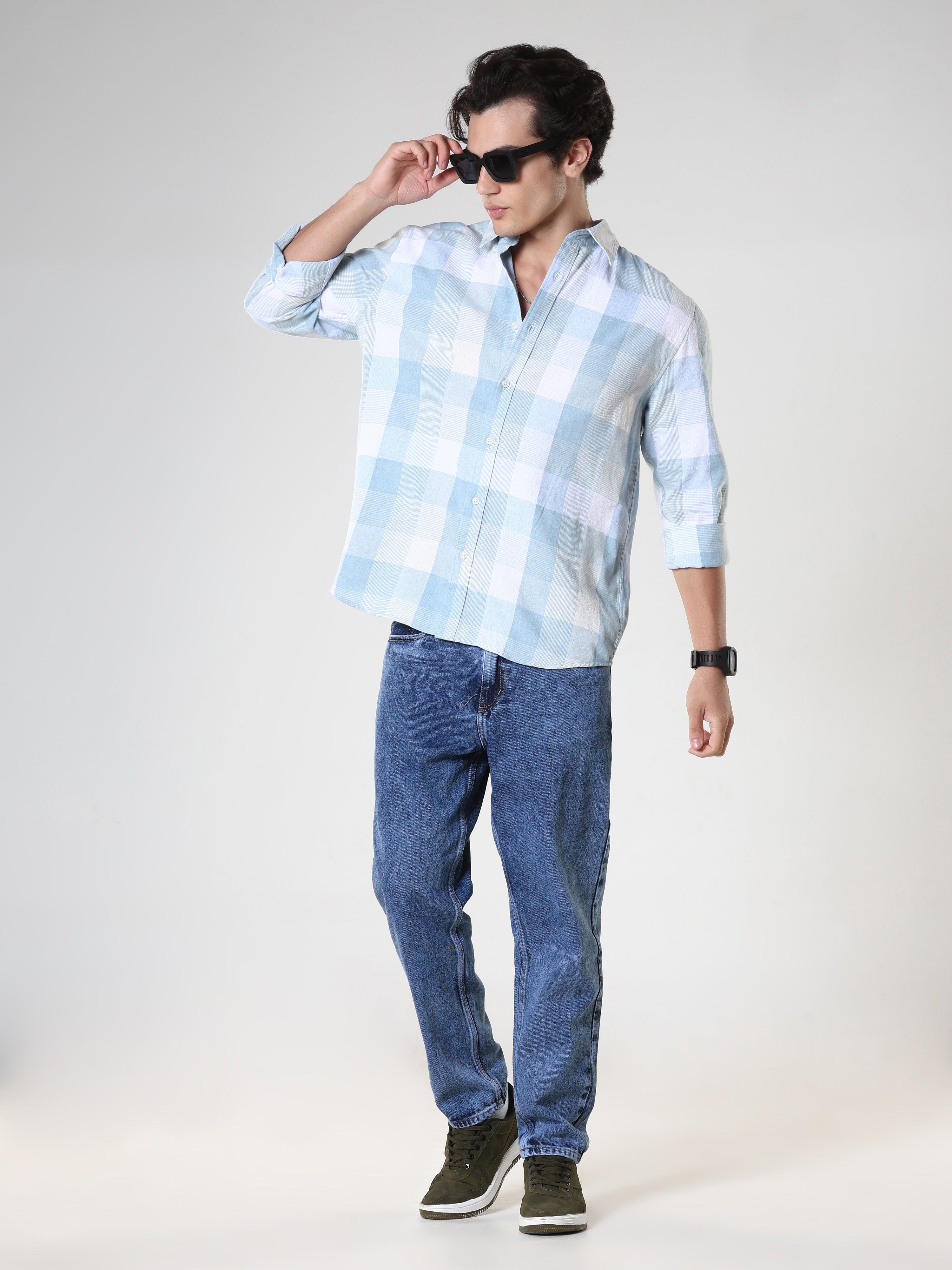 Men's casual sky blue checkered cotton shirt with full sleeves, relaxed fit – paired with denim jeans