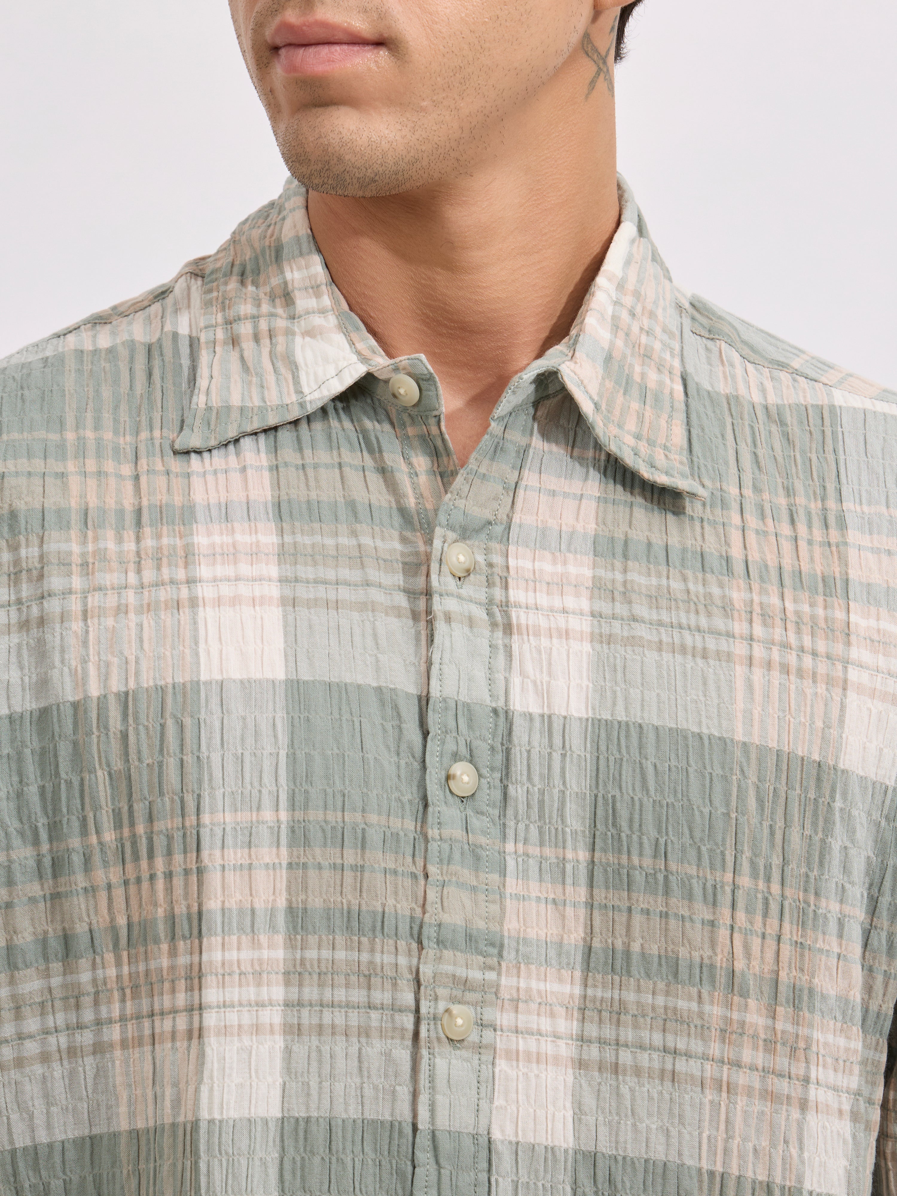 Men's oversized green checkered cotton shirt with full sleeves, styled with black jeans – casual fashion look