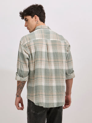 Men's oversized green checkered cotton shirt with full sleeves, styled with black jeans – casual fashion look