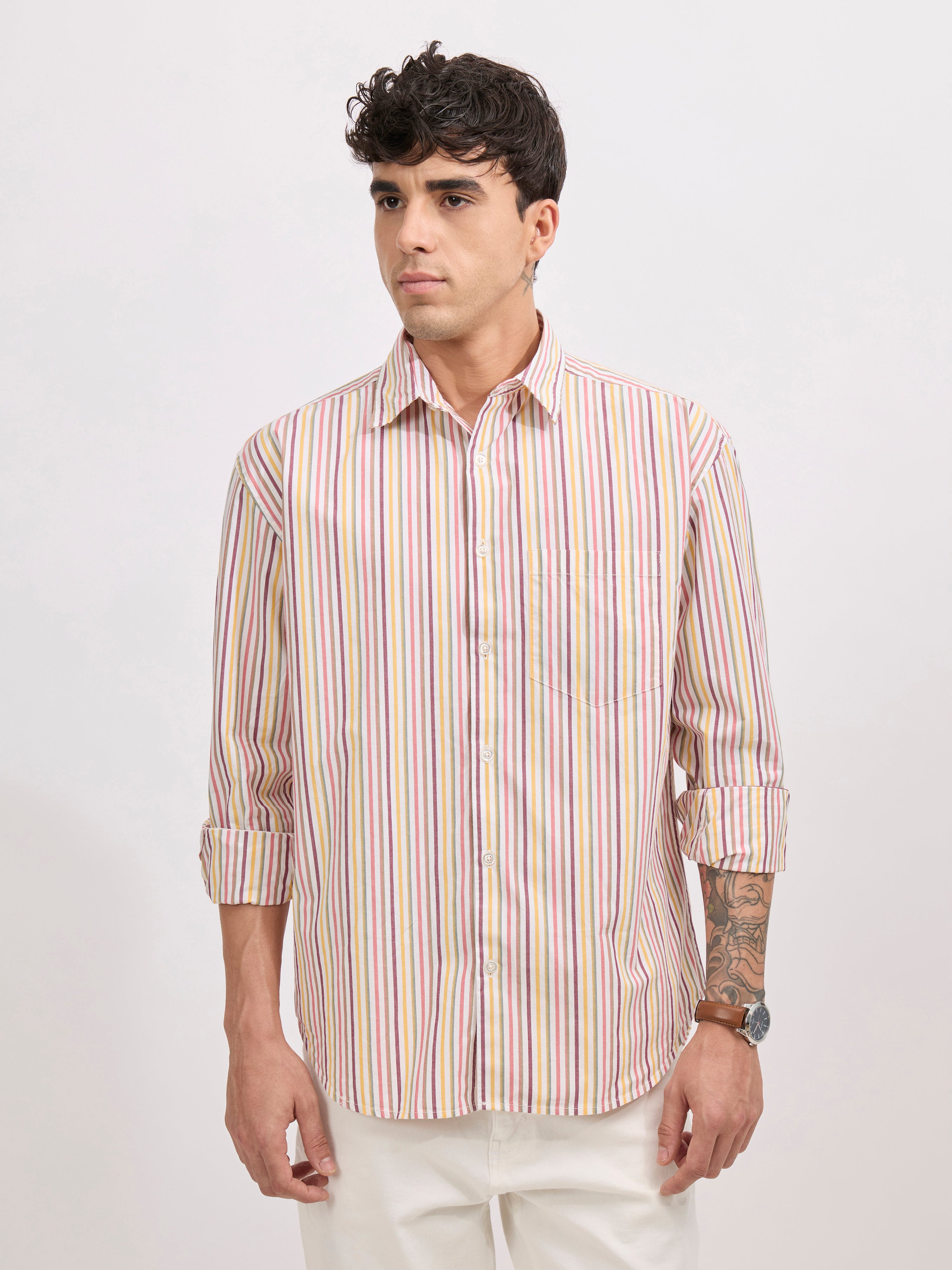 Man wearing a peach cotton oversized striped shirt with rolled sleeves, front pocket, and button-down collar
100% cotton
