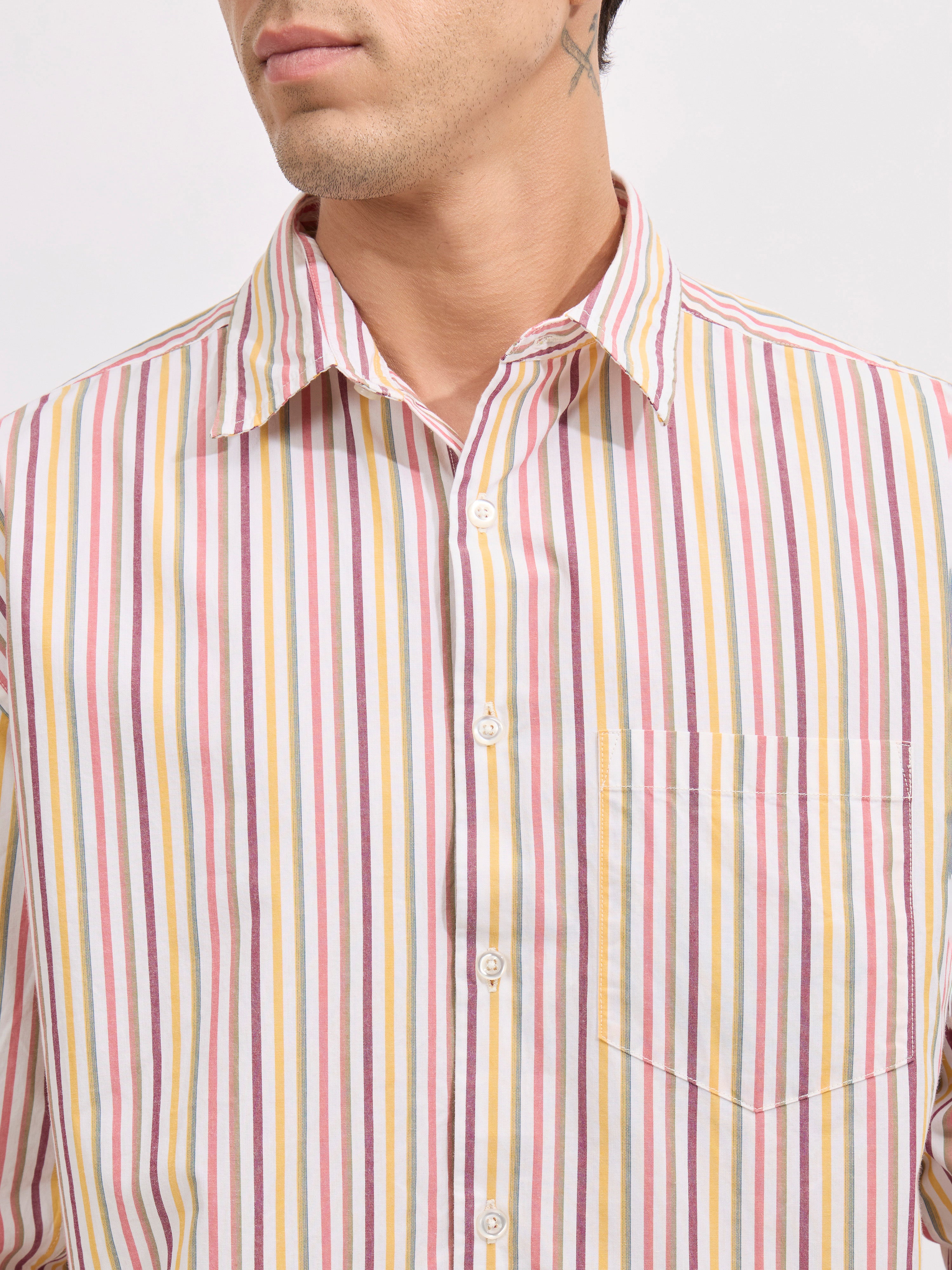 Man wearing a peach cotton oversized striped shirt with rolled sleeves, front pocket, and button-down collar
100% cotton
