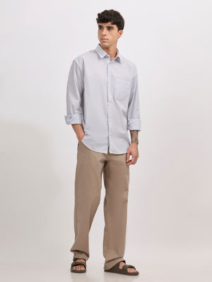 Man wearing grey cotton oversized striped shirt with rolled sleeves, front pocket, and button-down collar
100% cotton
