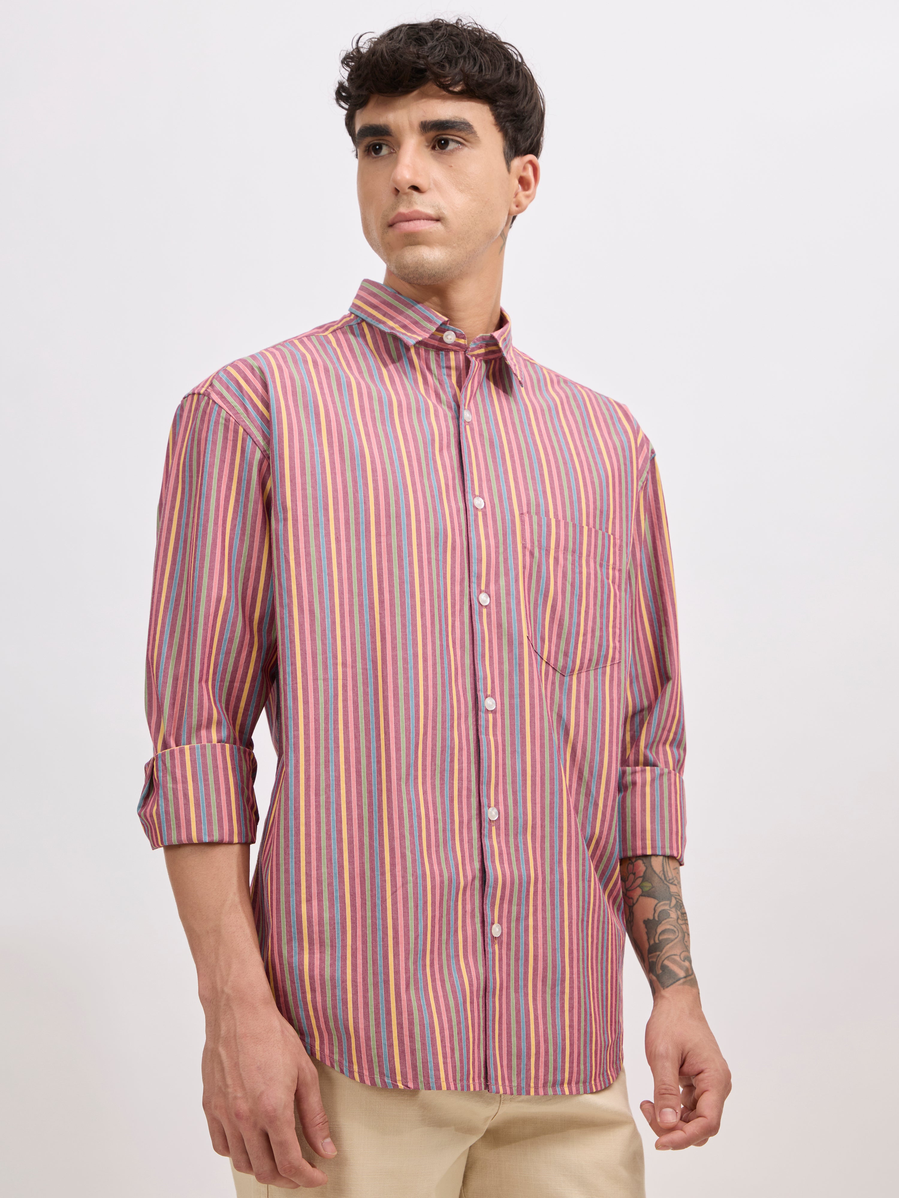 Man wearing a brick color cotton oversized striped shirt with rolled sleeves, front pocket, and button-down collar
100% cotton
