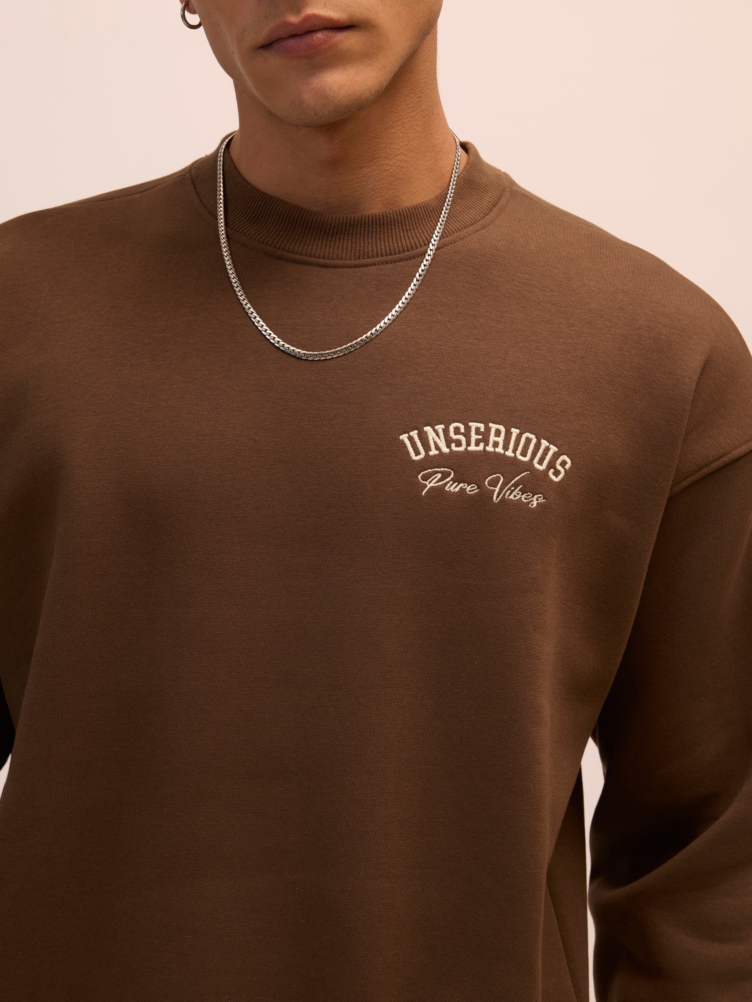 Men's choclate brown full sleeve fleece sweater tee with front chest print and soft winterwear.