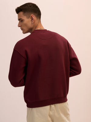 Men's maroon full sleeve fleece sweater tee with front chest print and soft winterwear.
