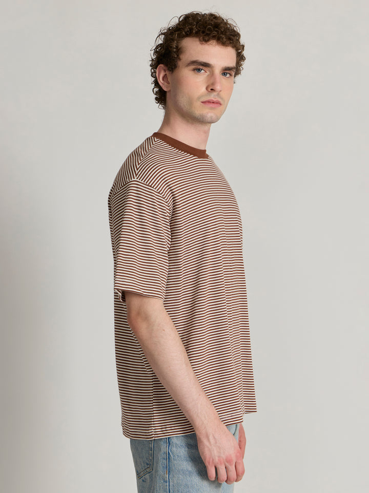 Man wearing a brown striped crew t-shirt 

