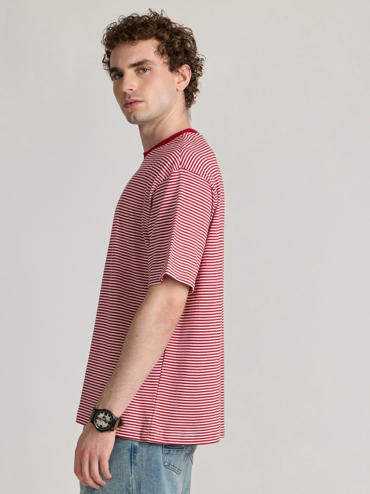 Man wearing a pink and white striped crew t-shirt 
