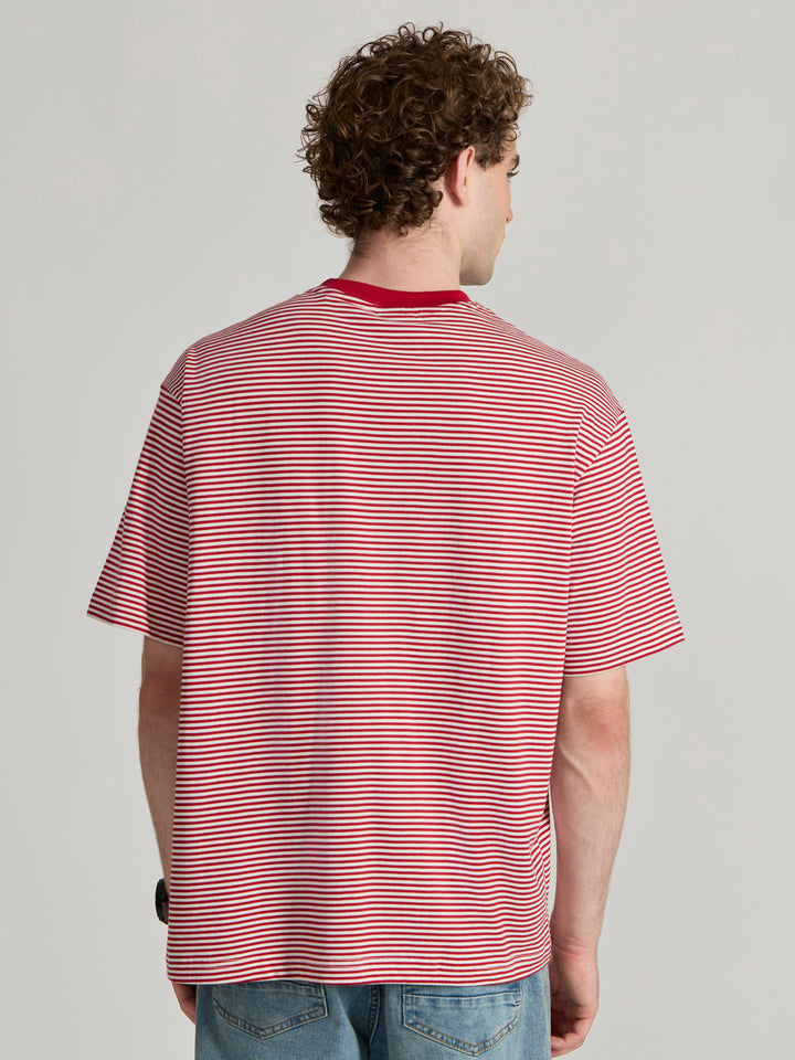 Man wearing a pink and white striped crew t-shirt 
