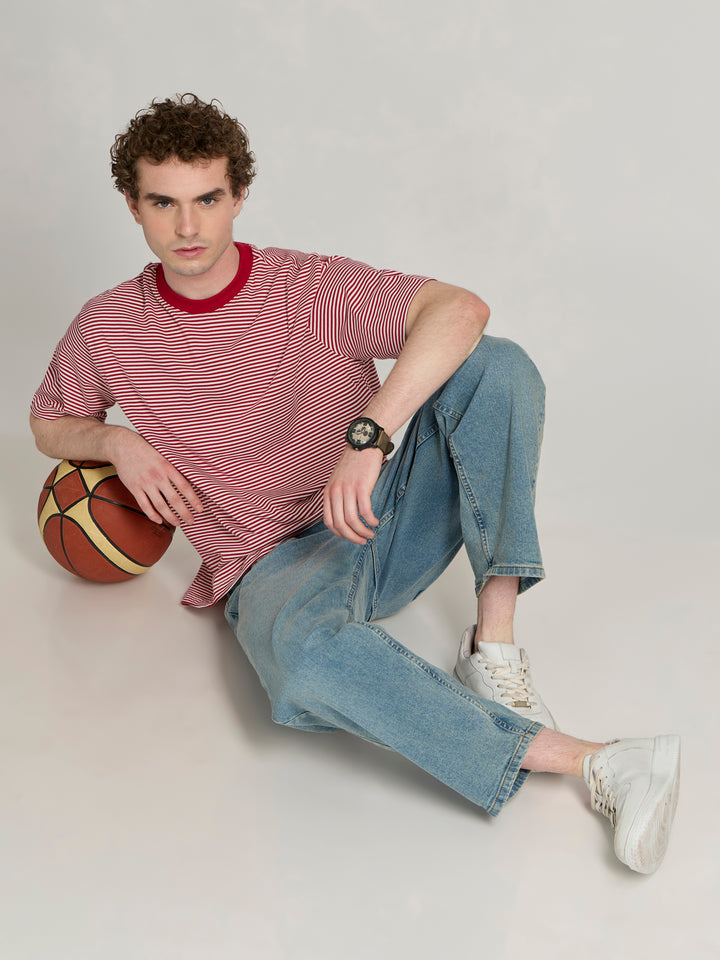 Man wearing a pink and white striped crew t-shirt 
