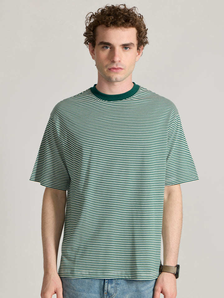 Man wearing a green  and white striped crew t-shirt 
