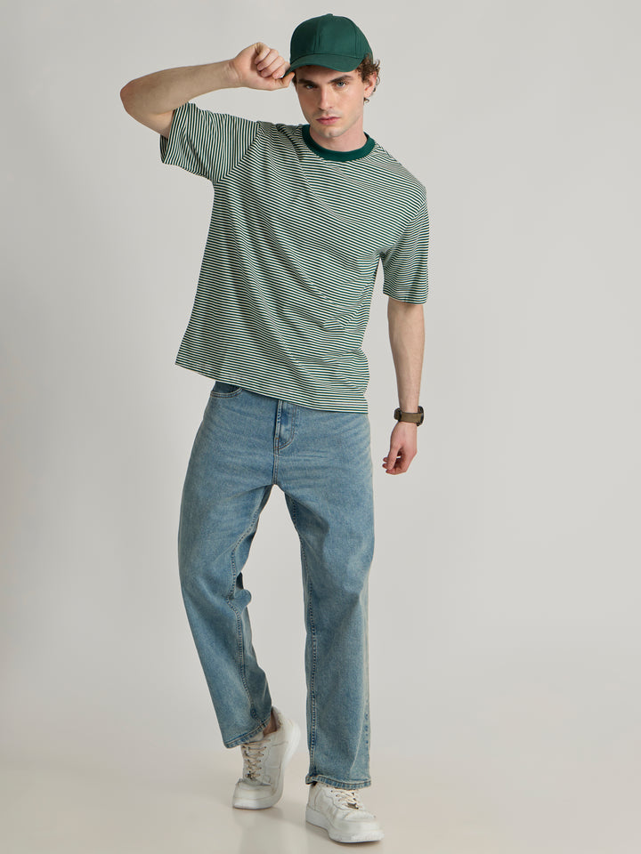 Man wearing a green  and white striped crew t-shirt 
