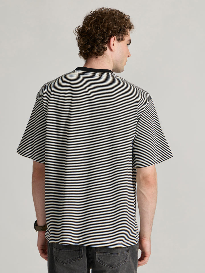 Man wearing a white and black striped crew t-shirt 
