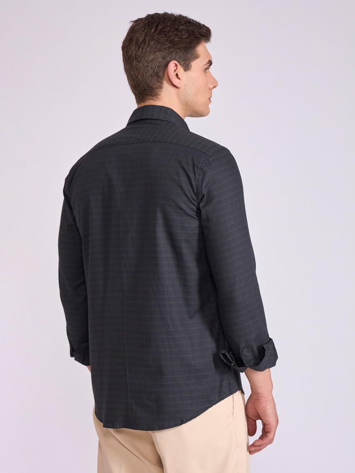 Man wearing a dark slate  gray checkered shirt.