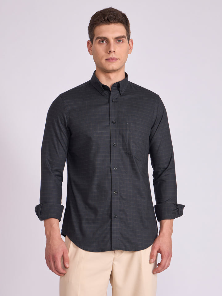 Man wearing a dark slate  gray checkered shirt.